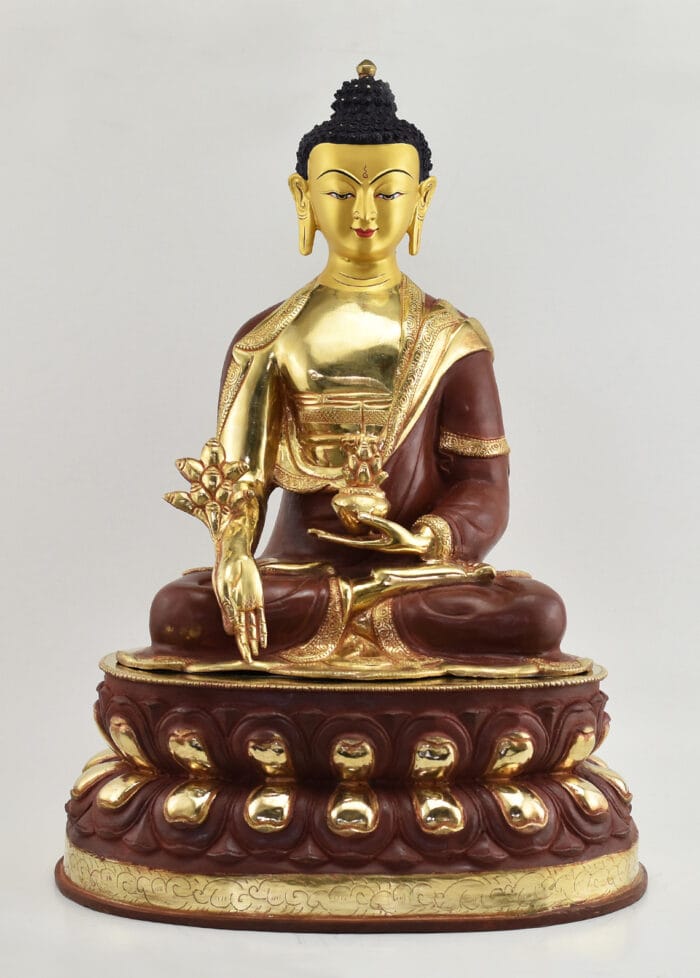 Front view of an 18.5-inch Tibetan Medicine Buddha sculpture seated in full lotus posture, holding a myrobalan plant and medicine bowl, with a hand-painted gold face, fire-gilded 24K gold body, deep red-brown robes and a two-tone double lotus throne.