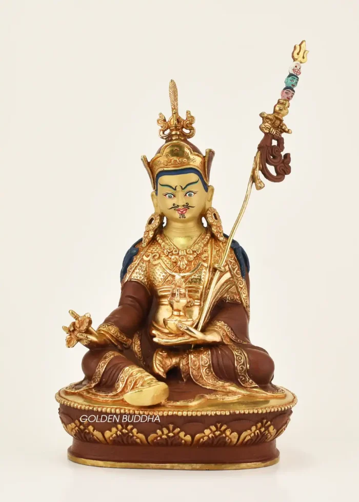 9.25-inch Guru Padmasambhava statue with 24K fire gilding, oxidized copper robes, blue hair, khatvanga with three impaled multicolored heads, kapala and lotus throne handcrafted in Nepal - gallery